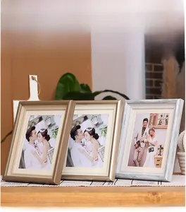 Detailed set of decorative photo frames in wood grain, champagne gold, and washed white