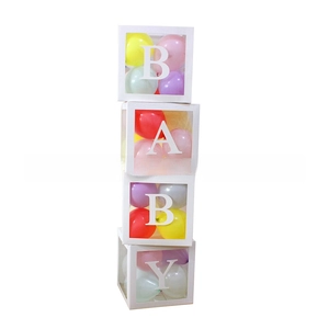 Detailed view of four transparent BABY balloon boxes with assorted colorful latex balloons