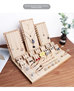 Macro detail of wooden jewelry display set with beige microfiber neck and ring pads