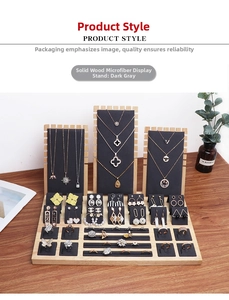 Detail of wooden jewelry display set with dark grey microfiber inserts and necklace stands