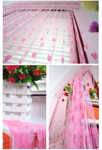 Detail of pink heart string curtain showing delicate fabric texture for home decoration