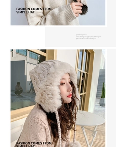 Detail of cream white knit trapper hat with fluffy faux fur lining and soft pom-poms