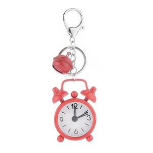 Mini red alarm clock keychain with metal ring and small bell on a white background