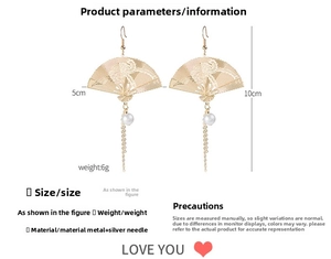 Detailed view of gold fan earrings with pearls and tassels including 10cm length dimensions