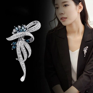 Elegant ribbon bow brooch featuring deep blue gemstones and white zircons on silver alloy