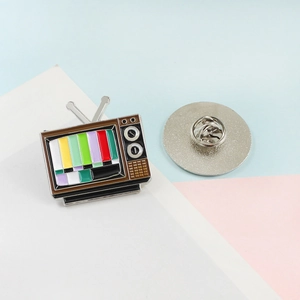 Vintage TV enamel pin with colorful signal stripes and metal butterfly clutch back