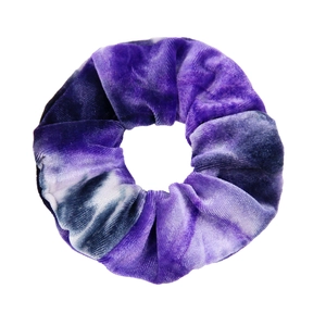 Detailed view of a purple tie-dye velvet hair scrunchie with soft gradient fabric texture