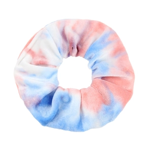 Macro shot of blue and pink tie-dye velvet hair scrunchie with soft fabric texture