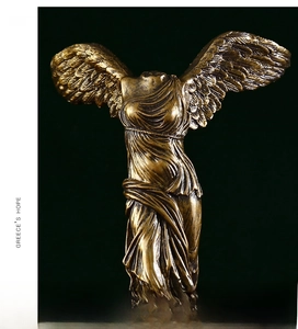 Detailed close-up of bronze Nike goddess statue with intricate wing and dress textures