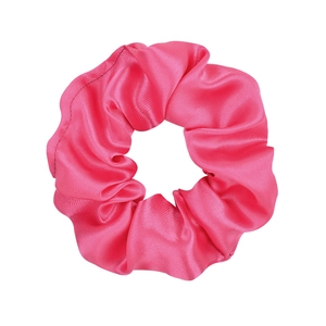 Detail shot of hot pink satin scrunchie showing glossy fabric texture and elastic design