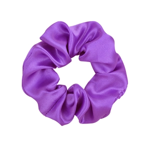 Macro shot of purple satin fabric scrunchie with elastic band and pleated texture details