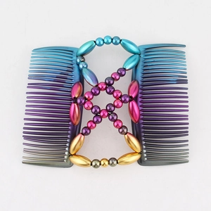 Detail of beaded magic hair comb with blue and purple metallic teeth for styling