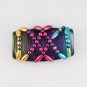 Detailed close-up of colorful beaded hair comb with gold, pink, and purple metal beads