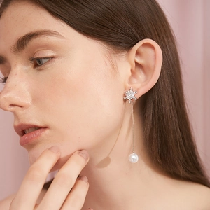 Elegant silver snowflake earrings with long tassel pearls and sparkling rhinestones