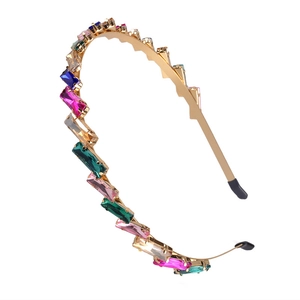 Elegant gold metal thin headband with colorful rectangular crystals on white background