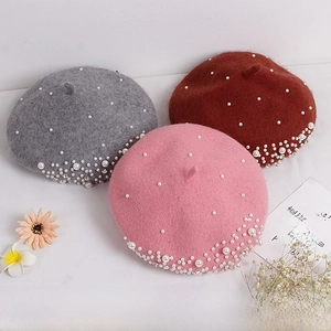 Detailed close-up of girls wool berets featuring pearl and rhinestone decorations in three colors