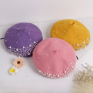 Close-up of wool berets for girls featuring elegant pearl and rhinestone decorations