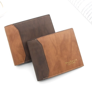 Detail of matte leather wallets featuring gold stamped logo and premium stitching texture