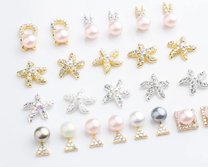 Star-shaped pink pearls and alloy nail art charms with rhinestone detailing