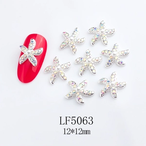 Macro detail of 12mm starfish nail art charm with silver base and white pearl inlay
