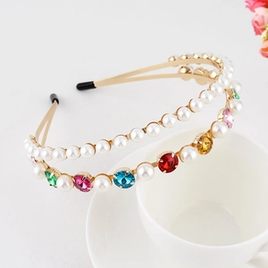 Detail of a double-layered gold headband with colorful rhinestones and faux pearls