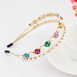 Detail of double-layer golden headband with colorful rhinestones and white pearls