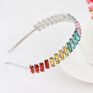 Detail of silver headband featuring gradient rainbow rhinestones and elegant metallic arc