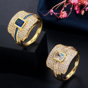 Close-up of gold-plated ring with square blue and clear zircon stones and micro-pave crystals