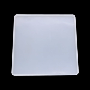 Close-up of square translucent silicone mold for DIY resin craft on black background