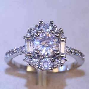 Elegant silver engagement ring with halo-set round zircon and tapered baguette stones