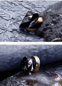 Macro view of geometric faceted steel rings with brushed finish and single diamond inlay