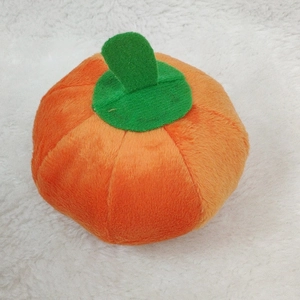 Orange pumpkin shaped squeaky plush dog toy made of durable soft material