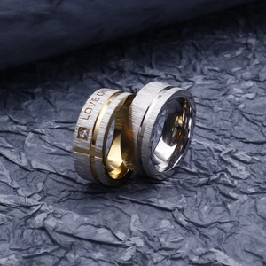Matching couple rings in stainless steel with love engraving and micro-set diamond accents