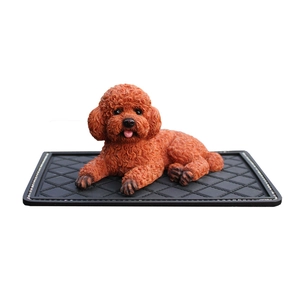 Realistic reddish-brown poodle teddy dog figurine on black non-slip mat for car dashboard