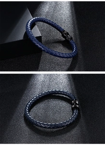 Macro shot of dark blue braided leather bracelet with glossy black cylindrical metal clasp