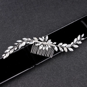 Detailed view of bridal silver hair comb with leaf-shaped marquise rhinestones in a gift box