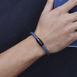 Men's woven microfiber leather bracelet in blue with black magnetic clasp on wrist
