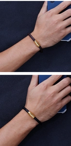 Dettaglio di bracciali in pelle intrecciata nera e marrone con chiusure magnetiche