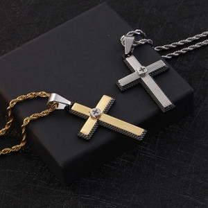 Two-tone stainless steel cross pendant necklaces with twisted chains on display box