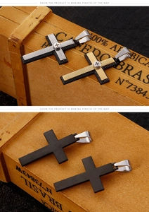 Macro detail of industrial dual-tone cross pendant in gold and silver stainless steel