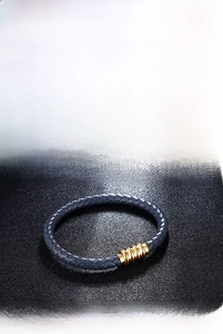 Detail of woven leather bracelet set with magnetic gold metal clasp in multiple colors