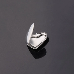 Polished 316L stainless steel heart locket pendant with a shiny mirror finish for photos