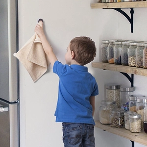 Adhesive wall hook for kitchen towels with a round silver finish and punch-free design