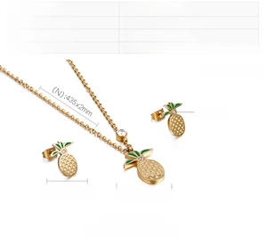 Detail of stainless steel gold pineapple jewelry set with green enamel and zircon stones