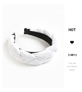 Detail of white velvet braided headband showing contrast black anti-slip lining