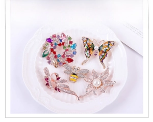 Detailed set of crystal animal and flower brooches with pearls and enamel on ceramic
