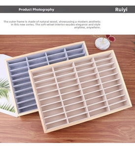 Macro shot of wooden jewelry tray with soft grey and beige velvet lining for bracelets
