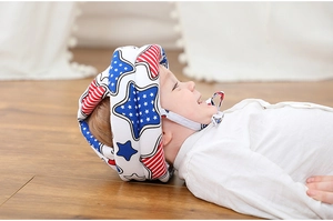 Detail showing toddler safety helmet with American flag pattern on a walking child