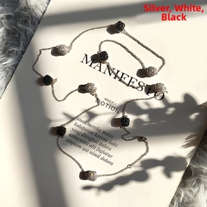 Detail of silver station necklace with square black and white pave crystal inserts