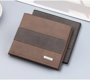 Detail of brown and grey leather bifold wallets with cross pattern and metal logo